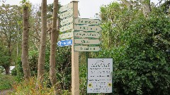 sign 
Little Sark; Pilcher MOnument; Stocks Hotel; Hathaways Cafe; Public Toilets; Cafe & Tea Garden; Le Seigneurie Gardens; Visitors Center; Island Hall