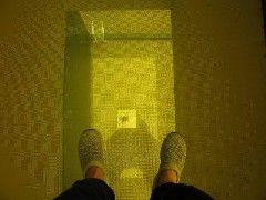 Lyn s feet- looking down through a glass floor in the Guthrie building Minneapolis Minnesota
