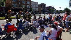 4th of July parade; firemen high fiving kids along the parade route